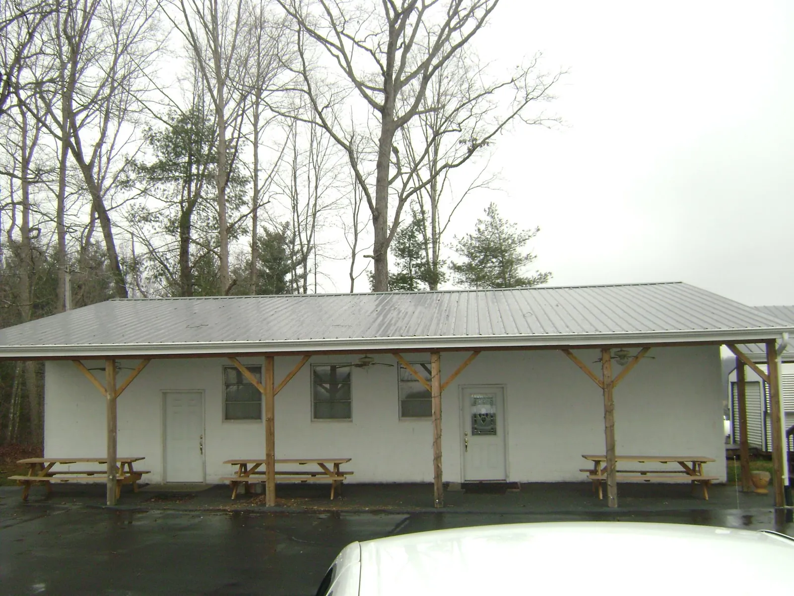 Gray metal roof over a block building with a timber post porch in Castleford